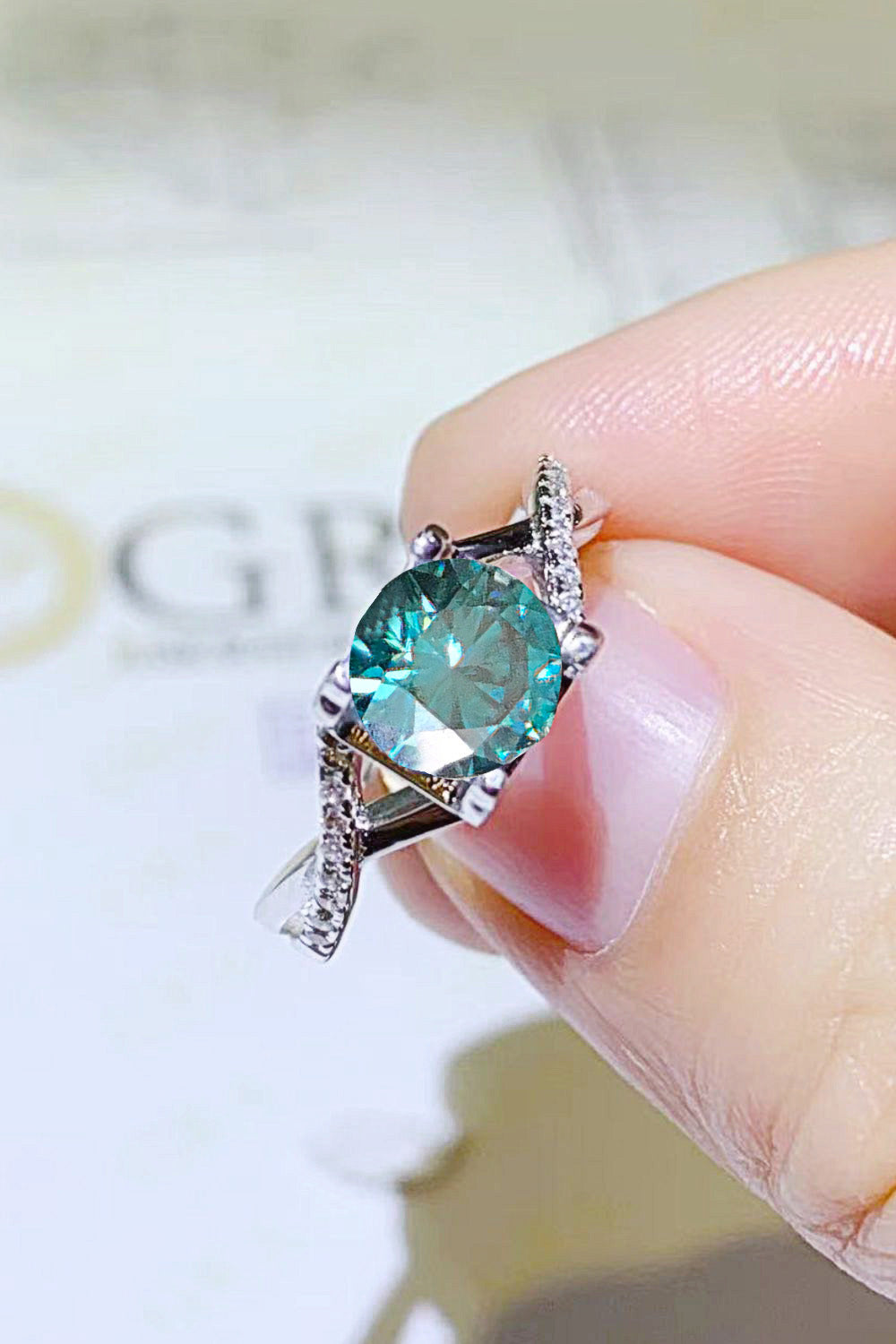 1 Carat Aqua Blue Round Brilliant Cut Moissanite Crisscross Platinum Over Pure Sterling Silver Ring - Sparkala