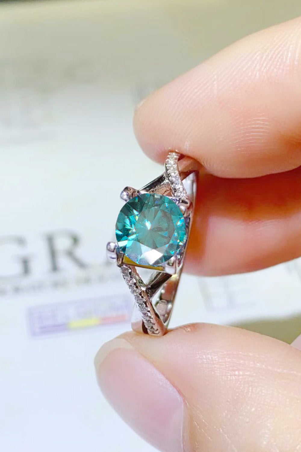 1 Carat Aqua Blue Round Brilliant Cut Moissanite Crisscross Platinum Over Pure Sterling Silver Ring - Sparkala